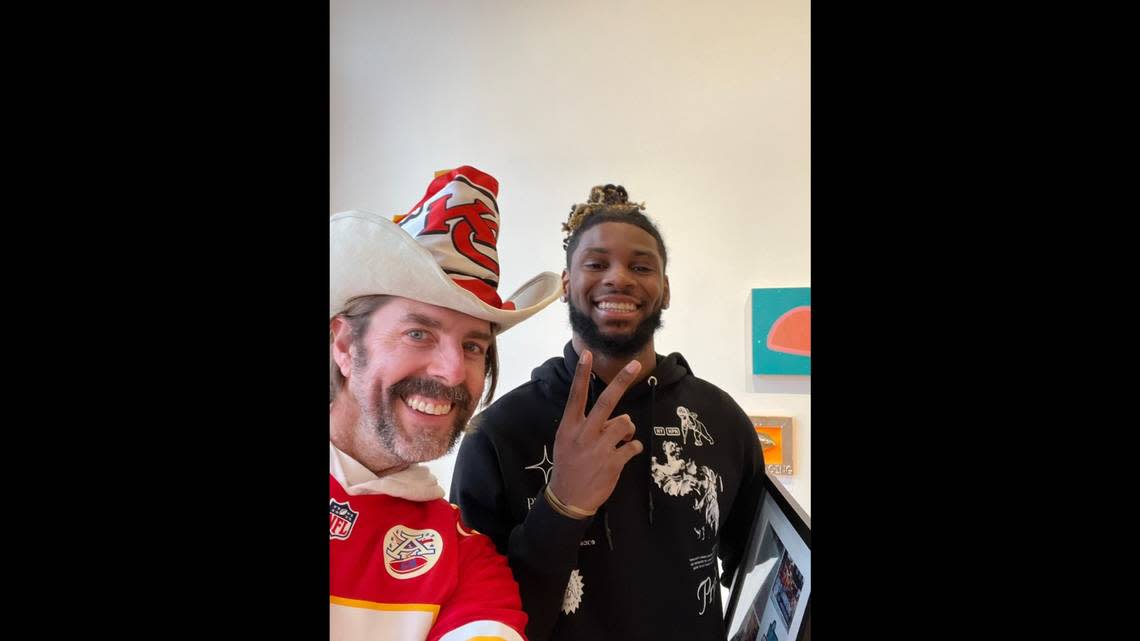 Chiefs fan Grant Mong takes a photo with Ihmir Smith-Marsette after the Chiefs wide receiver returned “Skelly,” a fake skeleton that made its rounds during the 2023 Super Bowl parade.