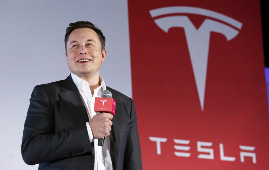 Tesla Motors CEO Elon Musk speaks to the media next to its Model S. (Photo by Nora Tam/South China Morning Post via Getty Images)