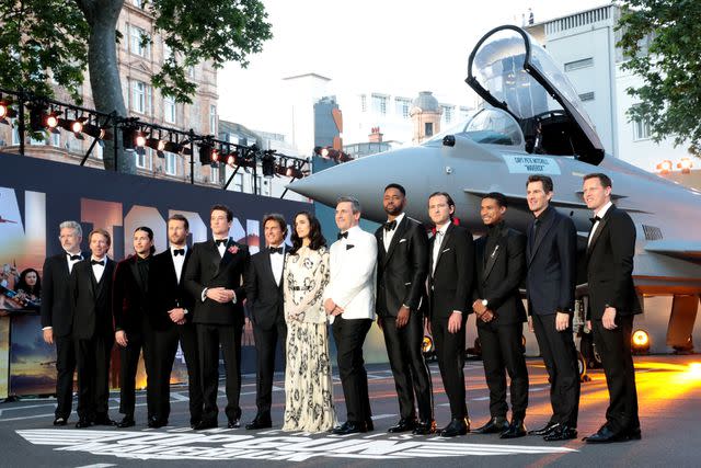 Anthony Sinclair/Getty Images From L: Christopher McQuarrie, Jerry Bruckheimer, Danny Ramirez, Glen Powell, Miles Teller, Tom Cruise, Jennifer Connelly, Jon Hamm, Jay Ellis, Lewis Pullman, Greg Tarzan Davis, Director Joseph Kosinski and David Ellison at the U.K. premiere of <em>Top Gun: Maverick</em> in London on May 19, 2022