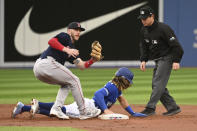 Toronto Blue Jays' Bo Bichette, center, is tagged out at second by Boston Red Sox second baseman Trevor Story, left, after being caught in a rundown in the second inning of a baseball game in Toronto, Monday, June 27, 2022. (Jon Blacker/The Canadian Press via AP)