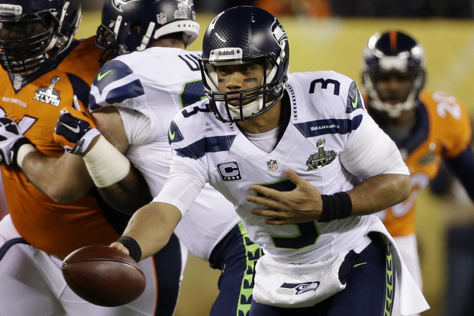 Seattle Seahawks' Russell Wilson looks to hand the ball off against the Denver Broncos during the first half of the NFL Super Bowl XLVIII football game Sunday, Feb. 2, 2014, in East Rutherford, N.J. (AP Photo/Mark Humphrey)