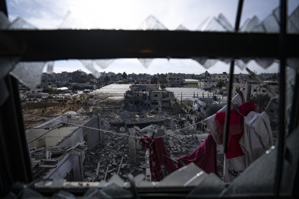 Palestinians inspect the damage to residential buildings where two Israeli hostages were reportedly held before being rescued during an operation by Israeli security forces in Rafah, southern Gaza Strip, Monday, Feb. 12, 2024. The Israeli military said early Monday that it had rescued the two hostages from captivity in the Gaza Strip. The operation, which was accompanied by airstrikes, killed dozens of Palestinians, according to local health officials. (AP Photo/Fatima Shbair)