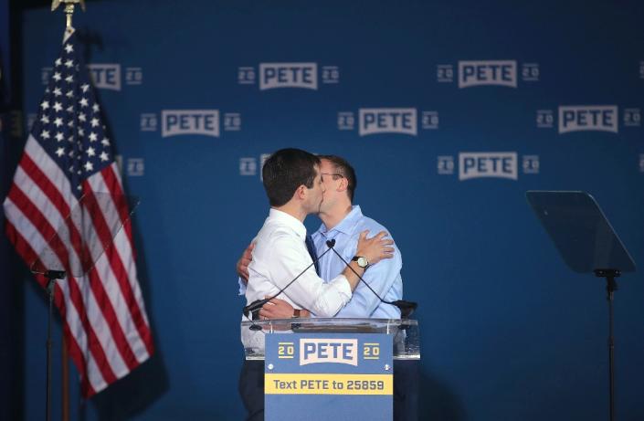 Pete Buttigieg, a previously little known Indiana mayor who has emerged as a serious contender for the Democratic presidential nomination in 2020, kisses his husband Chasten at a campaign event (AFP Photo/SCOTT OLSON)