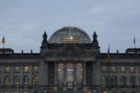 The building of German parliament, the Reichstag, is illuminated in Berlin, Tuesday, Oct. 26, 2021. Following the Sept. 26 national elections, the parliament Bundestag meet for a constituent parliamentary session. (AP Photo/Markus Schreiber)