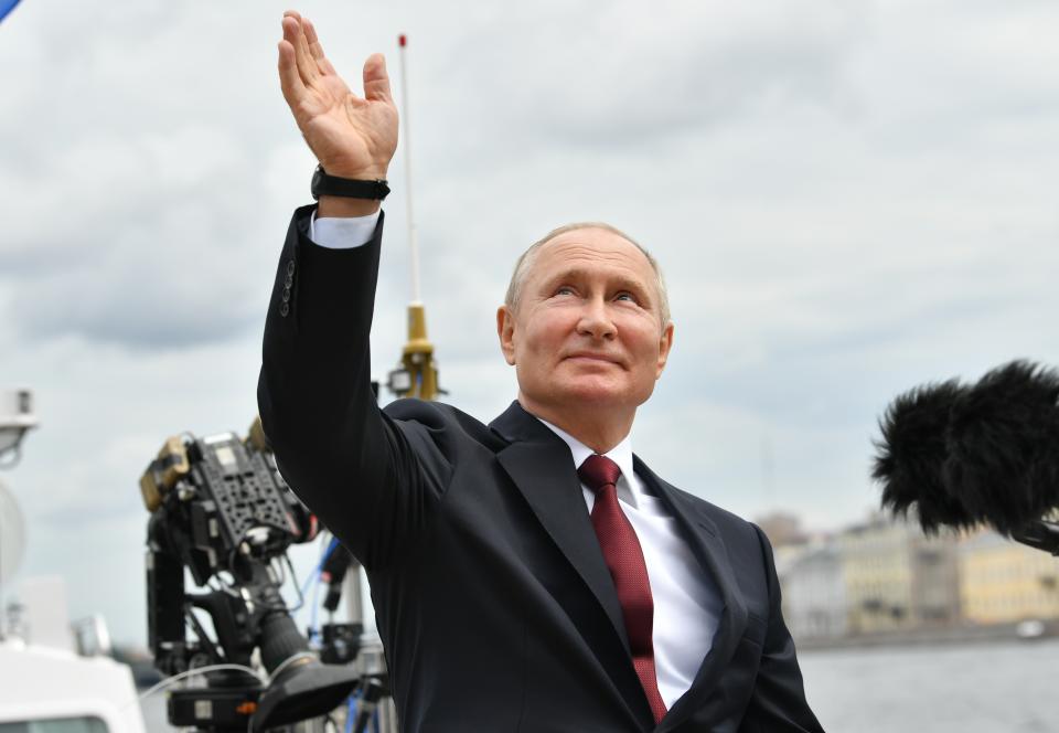 Russian President Vladimir Putin waves to spectators as he leaves the Navy Day parade in St. Petersburg, Russia, Sunday, July 25, 2021. (Alexei Nikolsky, Sputnik, Kremlin Pool Photo via AP)