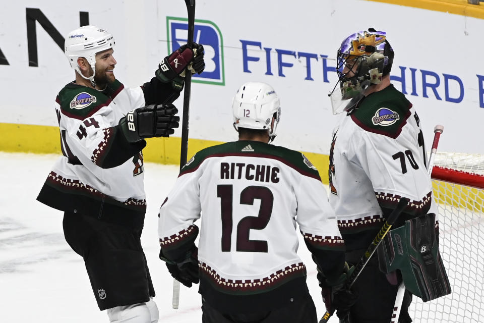 Arizona Coyotes goaltender Karel Vejmelka (70) is congratulated by right wing Zack Kassian (44) and left wing Nick Ritchie (12) after their win over the Nashville Predators in an NHL hockey game Monday, Feb. 13, 2023, in Nashville, Tenn. (AP Photo/Mark Zaleski)