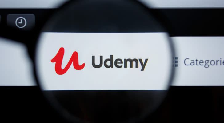 An image of the logo for Udemy through a lens.