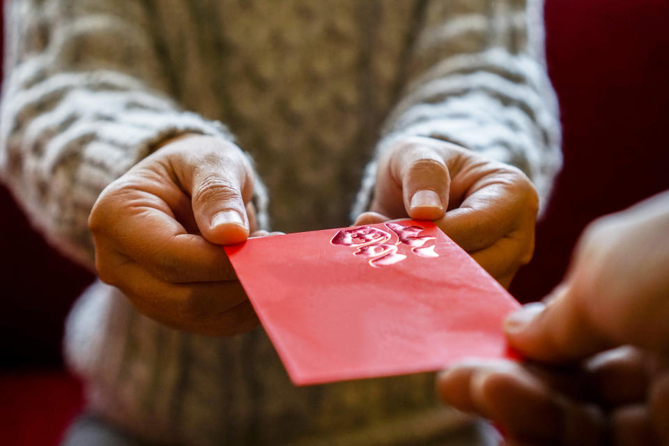 giving red envelope of money on holiday