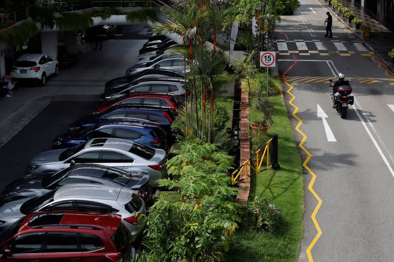 Cars for sale are parked at used car dealerships in Singapore