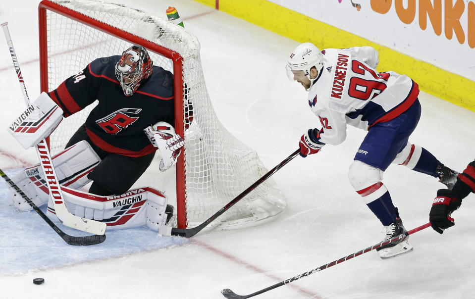 Carolina Hurricanes goalie Petr Mrazek, of the Czech Republic, defends against Washington Capitals' Evgeny Kuznetsov (92), of Russia, during the second period of Game 6 of an NHL hockey first-round playoff series in Raleigh, N.C., Monday, April 22, 2019. (AP Photo/Gerry Broome)