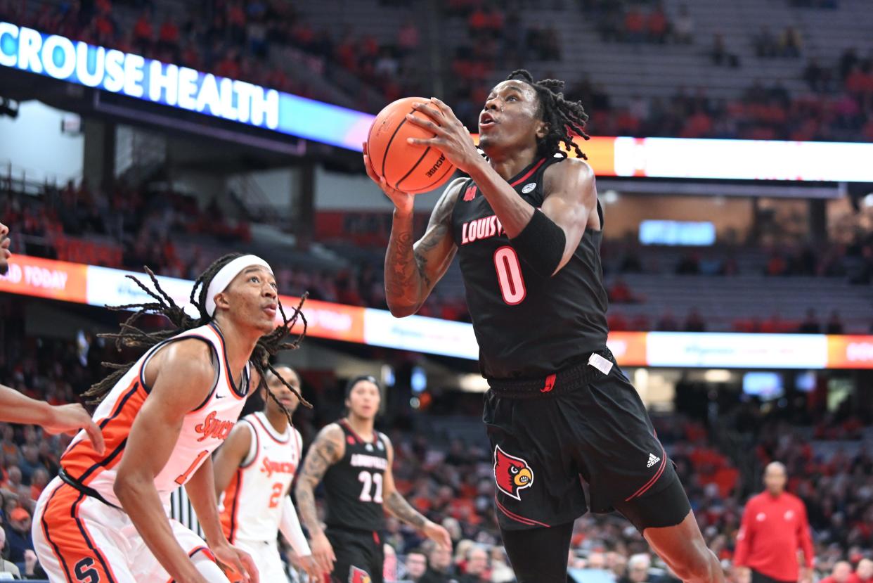 Feb 7, 2024; Syracuse, New York, USA; Louisville Cardinals guard Mike James (0) looks to shoot the ball with Syracuse Orange forward Maliq Brown (1) defending in the first half at the JMA Wireless Dome. Mandatory Credit: Mark Konezny-USA TODAY Sports