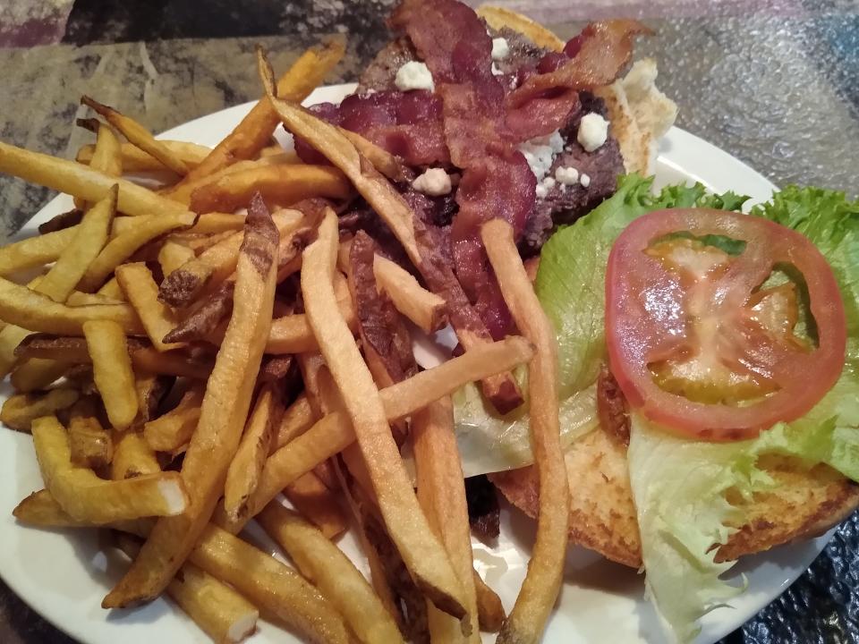 A bacon cheeseburger is served with fries at the Coventry Diner.