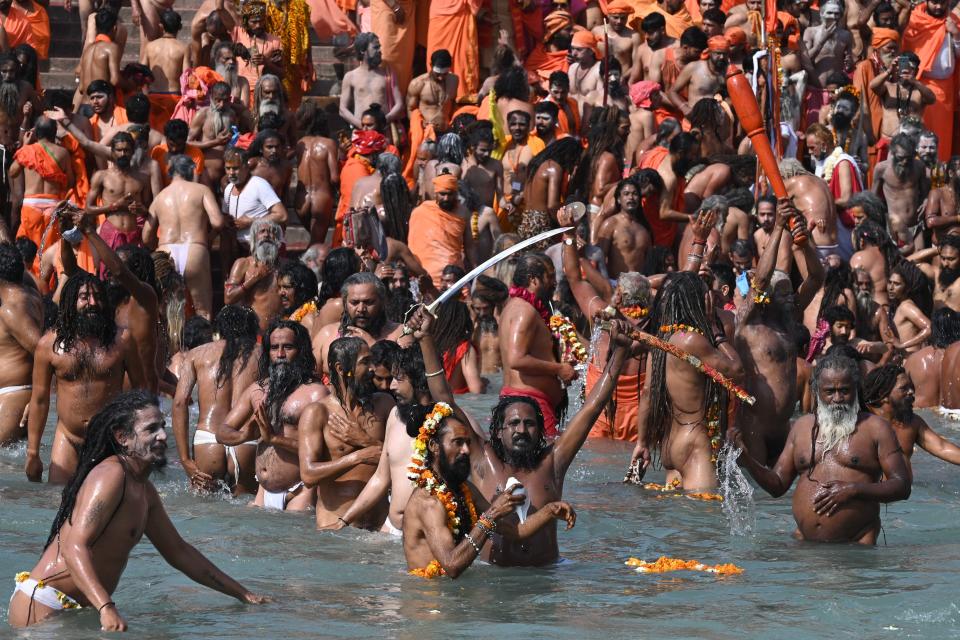 Naga Sadhus (Hindu holy men) take holy dip in the waters of the River Ganges on the Shahi snan (grand bath) on the occasion of Maha Shivratri festival during the ongoing religious Kumbh Mela festival in Haridwar on March 11, 2021. (Photo by Prakash SINGH / AFP) (Photo by PRAKASH SINGH/AFP via Getty Images)