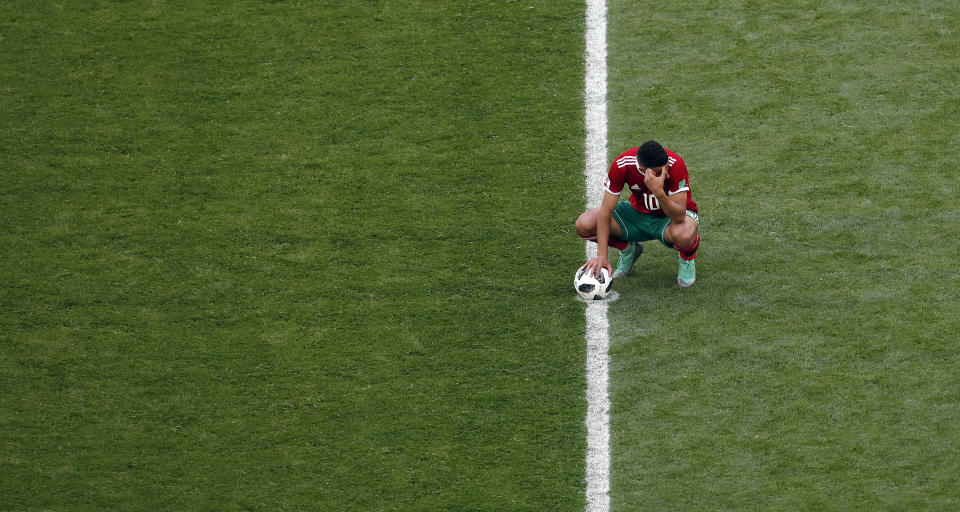 Morocco’s Younes Belhanda waits at the kick off point after his teammate Aziz Bouhaddouz scored an own goal (AP Photo/Darko Vojinovic)