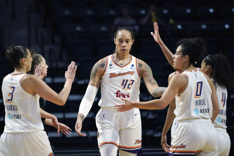 FILE - Phoenix Mercury's Brittney Griner (42) is congratulated on a play against the Seattle Storm in the first half of the second round of the WNBA basketball playoffs Sunday, Sept. 26, 2021, in Everett, Wash. Griner, who was a free agent, re-signed with the Mercury on a one-year contract according to a person familiar with the deal. The person spoke to The Associated Press on condition of anonymity on Saturday, Feb. 18, 2023, because no announcement has been made. (AP Photo/Elaine Thompson, File)