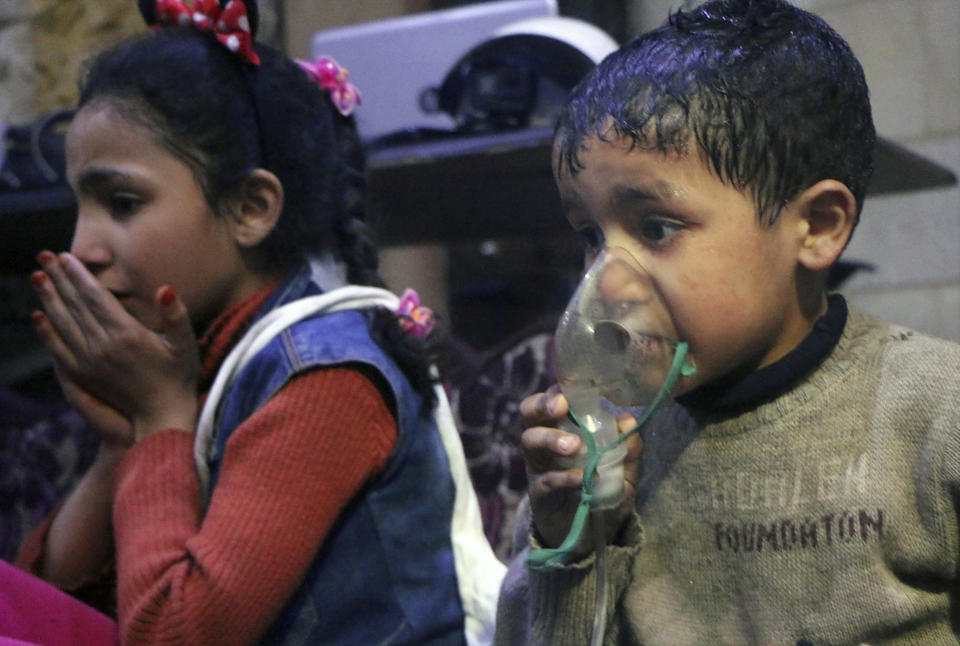 <p>This image released early Sunday, April 8, 2018 by the Syrian Civil Defense White Helmets, shows a child receiving oxygen through respirators following an alleged poison gas attack in the rebel-held town of Douma, near Damascus, Syria. (Photo: Syrian Civil Defense White Helmets via AP) </p>