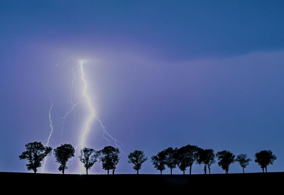 Lightning striking the ground during thunderstorm.