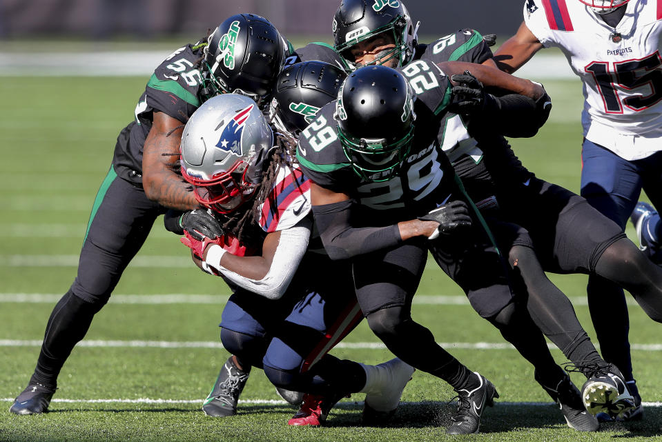 New England Patriots running back Rhamondre Stevenson (38) is tackled by the New York Jets during the second quarter of an NFL football game, Sunday, Oct. 30, 2022, in New York. (AP Photo/Noah Murray)