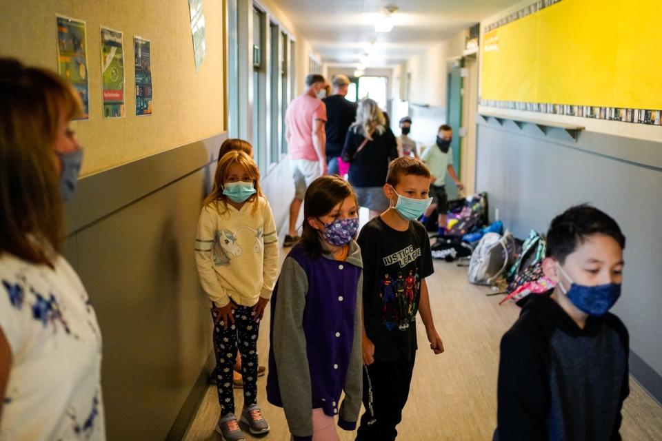 Principal Katie Poburko watch students line up to enter their classroom at Weaverville Elementary School