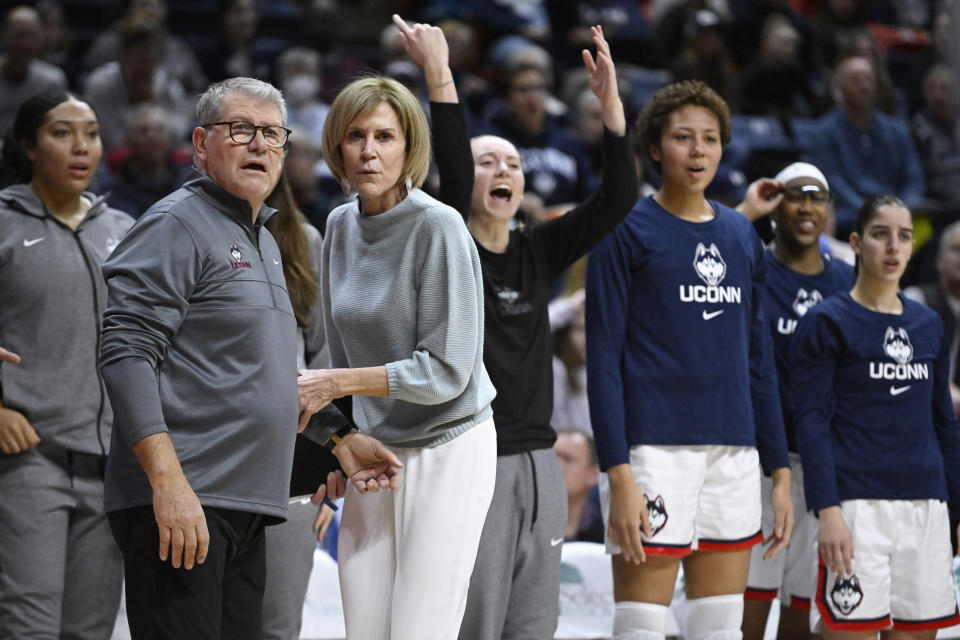 UConn head coach Geno Auriemma, front left, is held back by associate head coach Chris Dailey while questioning an official in the first half of an NCAA college basketball game against DePaul, Monday, Jan. 23, 2023, in Storrs, Conn. (AP Photo/Jessica Hill)