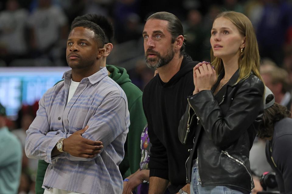 Randall Cobb, Aaron Rodgers and Mallory Edens watch Game Two of the Eastern Conference First Round Playoffs between the Milwaukee Bucks and the Chicago Bulls at Fiserv Forum on April 20, 2022 in Milwaukee, Wisconsin.