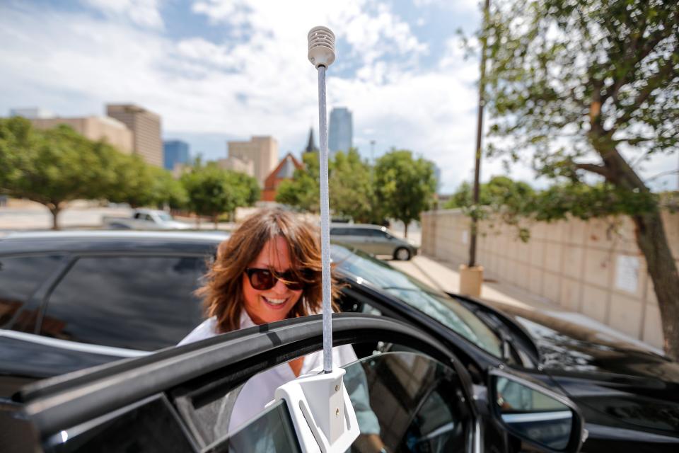 Liz Bowman places an air quality monitor on her car Aug. 12 as she and Councilwoman JoBeth Hamon prepare to ride a route through Oklahoma City and collect environmental data during an "urban heat island" mapping campaign for the city.