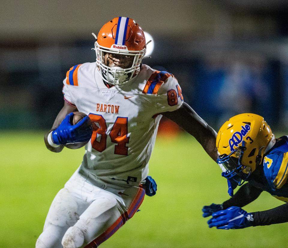 Bartow (84) Tranell Smith fends off a tackle by Auburndale defenders during first half action in Auburndale Fl. Friday September 22 ,2023.
Ernst Peters/The Ledger