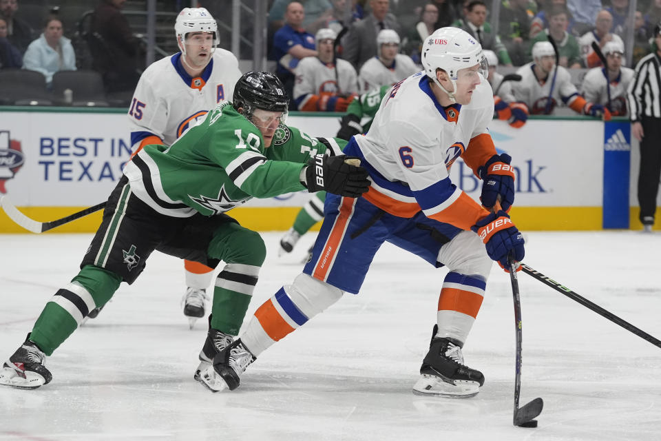 New York Islanders defenseman Ryan Pulock (6) moves the puck against Dallas Stars center Ty Dellandrea (10) during the first period an NHL hockey game in Dallas, Monday, Feb. 26, 2024. (AP Photo/LM Otero)