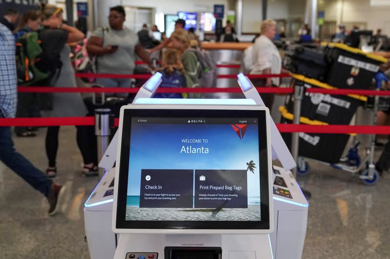 FILE PHOTO: Passengers line up before their flights at Hartsfield-Jackson Atlanta International Airport