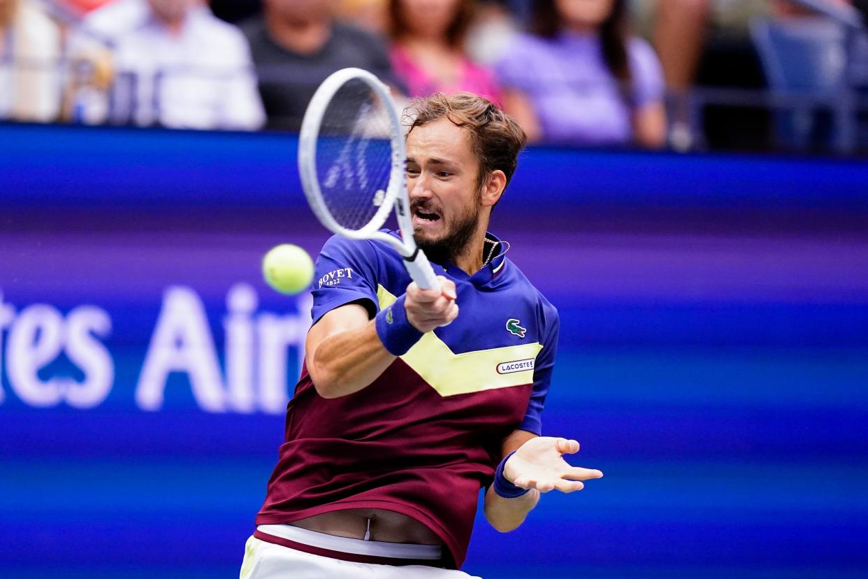 Daniil Medvedev returns a shot to Novak Djokovic (AP)