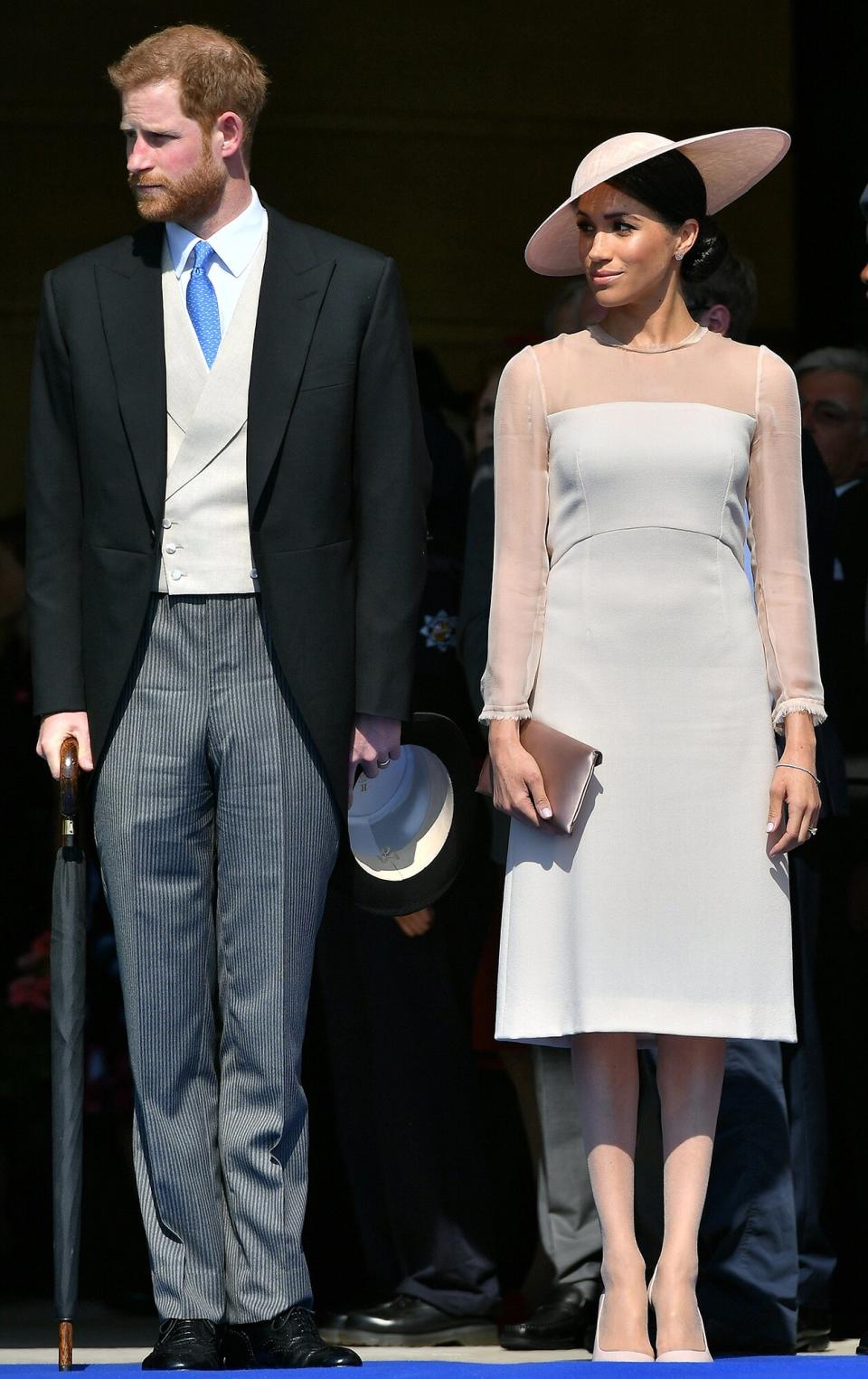 Prince Harry, Duke of Sussex (L), and his new wife, Britain's Meghan, Duchess of Sussex, attend the Prince of Wales's 70th Birthday Garden Party at Buckingham Palace in London on May 22, 2018. - The Prince of Wales and The Duchess of Cornwall hosted a Garden Party to celebrate the work of The Prince's Charities in the year of Prince Charles's 70th Birthday