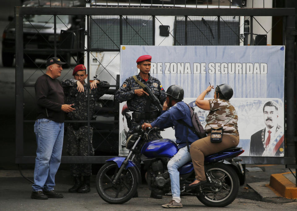 Residents speaks with National Police at the entrance of Helicoide prison in Caracas, Venezuela, Thursday, May 9, 2019, where Edgar Zambrano, vice president of the opposition-controlled National Assembly is being held after his arrest the previous night. The arrest of Zambrano unleashed fears of a wider crackdown on Thursday, even as members of the opposition issued renewed calls for weekend protests in a months long campaign to oust President Nicolás Maduro. (AP Photo/Fernando Llano)