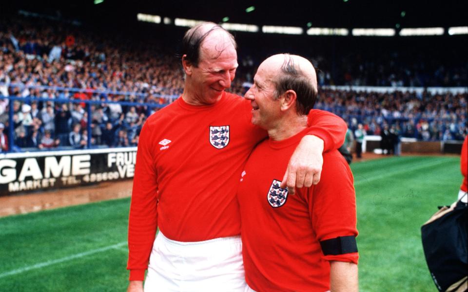 The Charlton brothers Jack and Bobby embrace at the match in aid of the Bradford fire disaster - POPPERFOTO