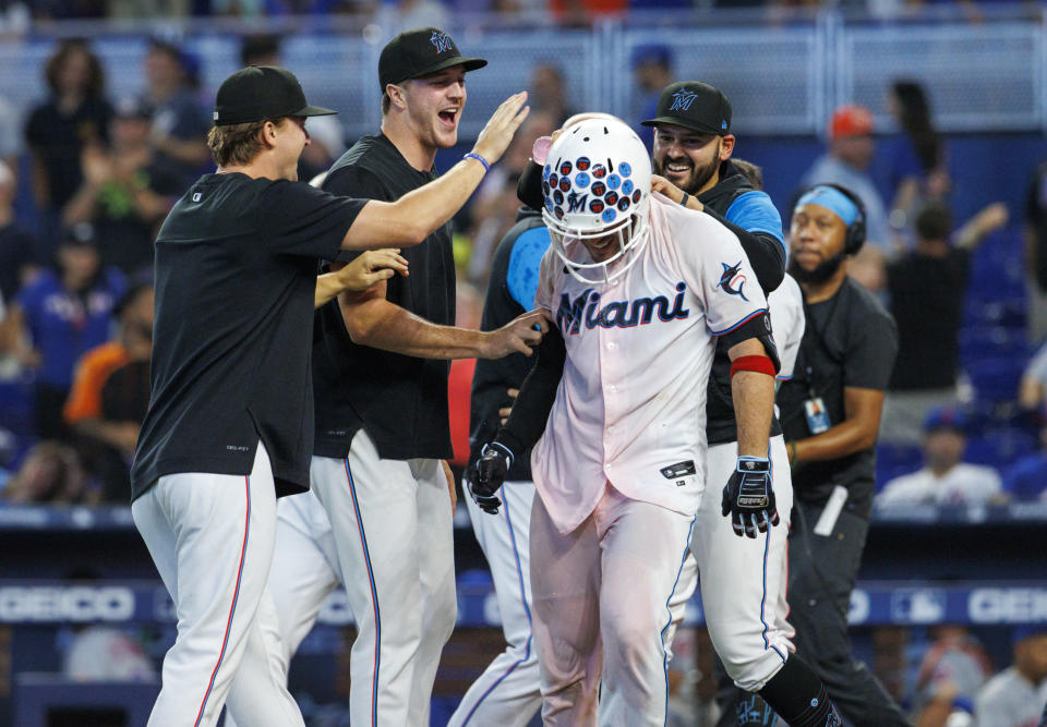 Miami Marlins' Nick Fortes, front right, celebrates with teammates after hitting a walkoff solo home run during the ninth inning of a baseball game against the New York Mets, Sunday, June 26, 2022, in Miami. (David Santiago/Miami Herald via AP)