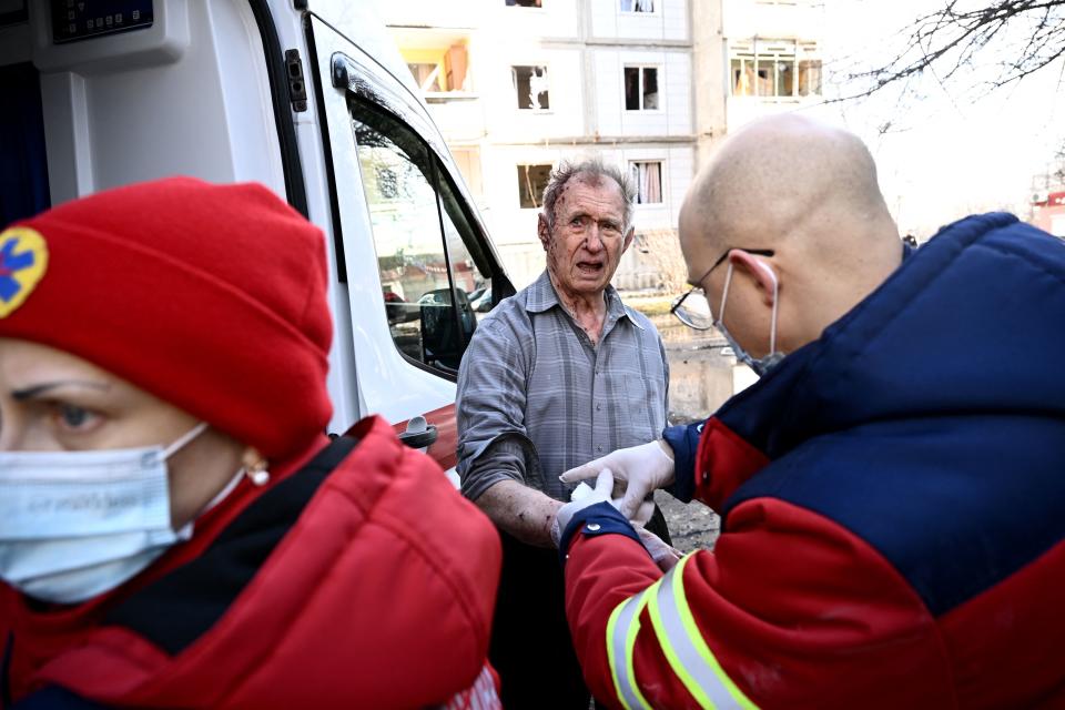 Emmergency unit staff treat an injured man after bombings on the eastern Ukraine town of Chuguiv on February 24, 2022, as Russian armed forces are trying to invade Ukraine from several directions, using rocket systems and helicopters to attack Ukrainian position in the south, the border guard service said. - Russia's ground forces on Thursday crossed into Ukraine from several directions, Ukraine's border guard service said, hours after President Vladimir Putin announced the launch of a major offensive. Russian tanks and other heavy equipment crossed the frontier in several northern regions, as well as from the Kremlin-annexed peninsula of Crimea in the south, the agency said. (Photo by Aris Messinis / AFP) (Photo by ARIS MESSINIS/AFP via Getty Images)