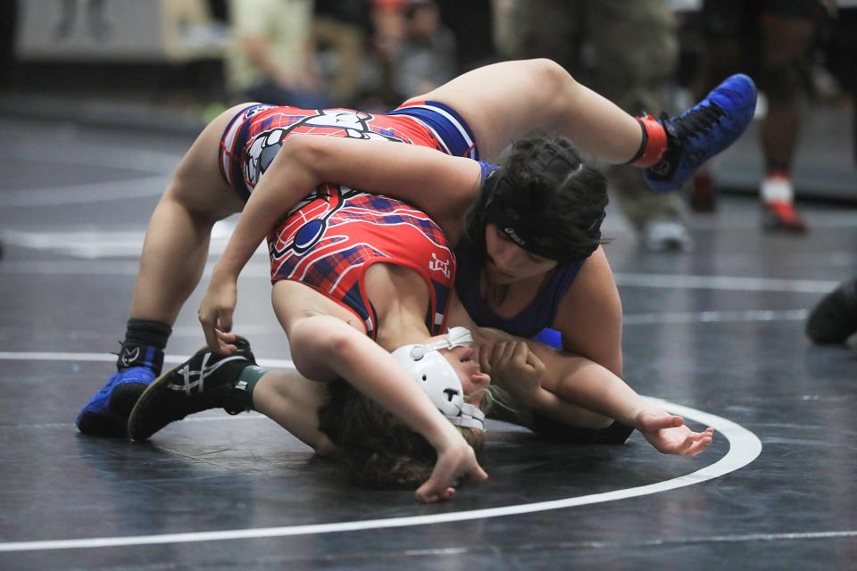 Wrestler Abigail Sotelo of San Elizario defeats Crystal De Avila of Bel Air at J.M. Hanks High School on Saturday, Feb. 4.