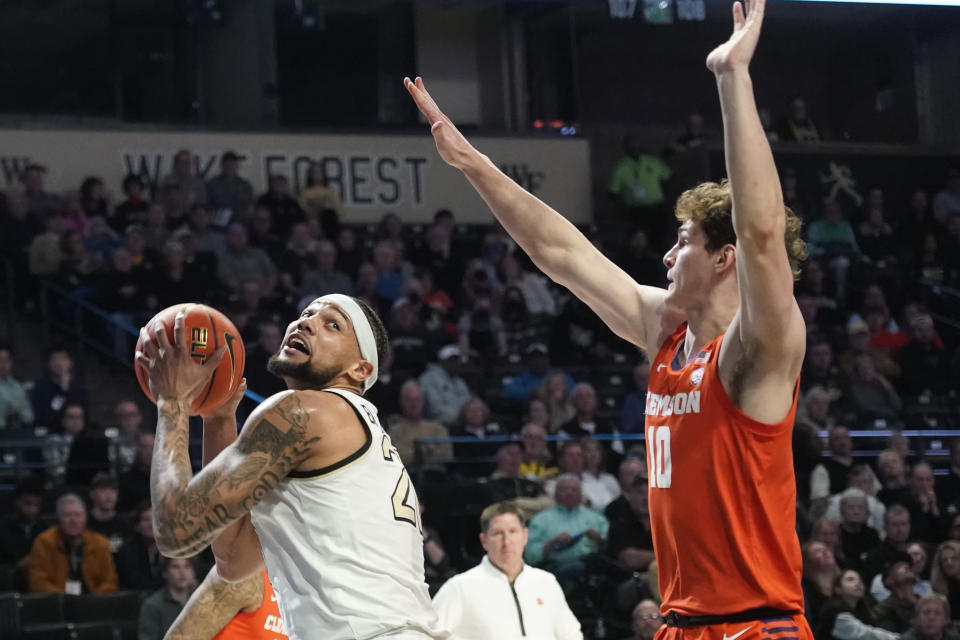 Wake Forest forward Davion Bradford, left, drives against Clemson forward Ben Middlebrooks during the first half of an NCAA college basketball game in Winston-Salem, N.C., Tuesday, Jan. 17, 2023. (AP Photo/Chuck Burton)