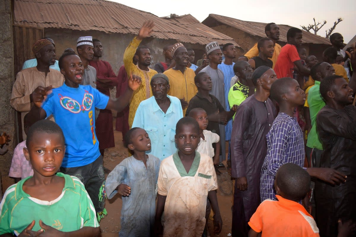 People gather around an area were gunmen kidnapped school children in Chikun, Nigeria, Thursday, 7 March 2024 (AP)