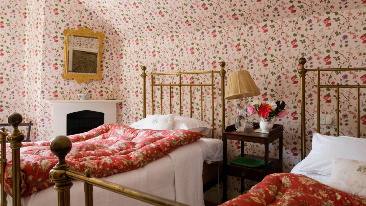 Bedroom with floral patterned wallpaper