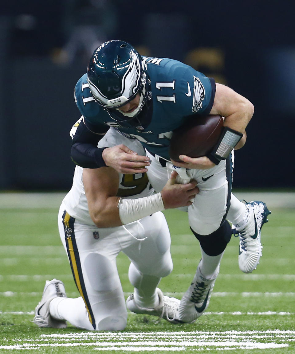 New Orleans Saints defensive end Trey Hendrickson tries to drag down Philadelphia Eagles quarterback Carson Wentz (11) in the first half of an NFL football game in New Orleans, Sunday, Nov. 18, 2018. (AP Photo/Butch Dill)