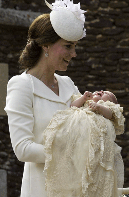 The Duchess of Cambridge carrying Princess Charlotte into St Mary Magdalene Church, where she was baptised by the Archbishop of Canterbury.