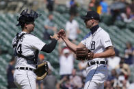 Detroit Tigers catcher Jake Rogers and relief pitcher Alex Lange meet after the ninth inning of a baseball game against the Texas Rangers, Wednesday, May 31, 2023, in Detroit. (AP Photo/Carlos Osorio)