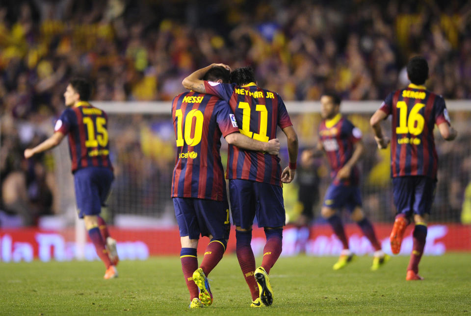 Barcelona's Lionel Messi, center left, and Neymar celebrate after Marc Bartra, left, scored their side's first goal during the final of the Copa del Rey between FC Barcelona and Real Madrid at the Mestalla stadium in Valencia, Spain, Wednesday, April 16, 2014. (AP Photo/Manu Fernandez)