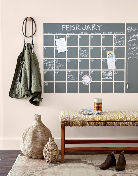 <p>Keep everyone in the loop with an entryway wall calendar. Use painter’s tape (we used a 1/2-inch-wide roll) to tape off a 35-square grid to desired size, as well as two rectangles, as shown. Paint with acrylic chalkboard paint (we used Behr’s Interior Chalk Decorative Paint). Once dry, remove tape, and touch up any rough edges. Tie a length of twine around a piece of chalk, knot end, and hang on wall with a pushpin. </p><p><a class="link " href="https://www.amazon.com/Chuangdi-Multi-use-Painters-Drafting-Scrapbooking/dp/B07YKV1142/?tag=syn-yahoo-20&ascsubtag=%5Bartid%7C10050.g.31153820%5Bsrc%7Cyahoo-us" rel="nofollow noopener" target="_blank" data-ylk="slk:SHOP PAINTER'S TAPE;elm:context_link;itc:0;sec:content-canvas">SHOP PAINTER'S TAPE</a></p>