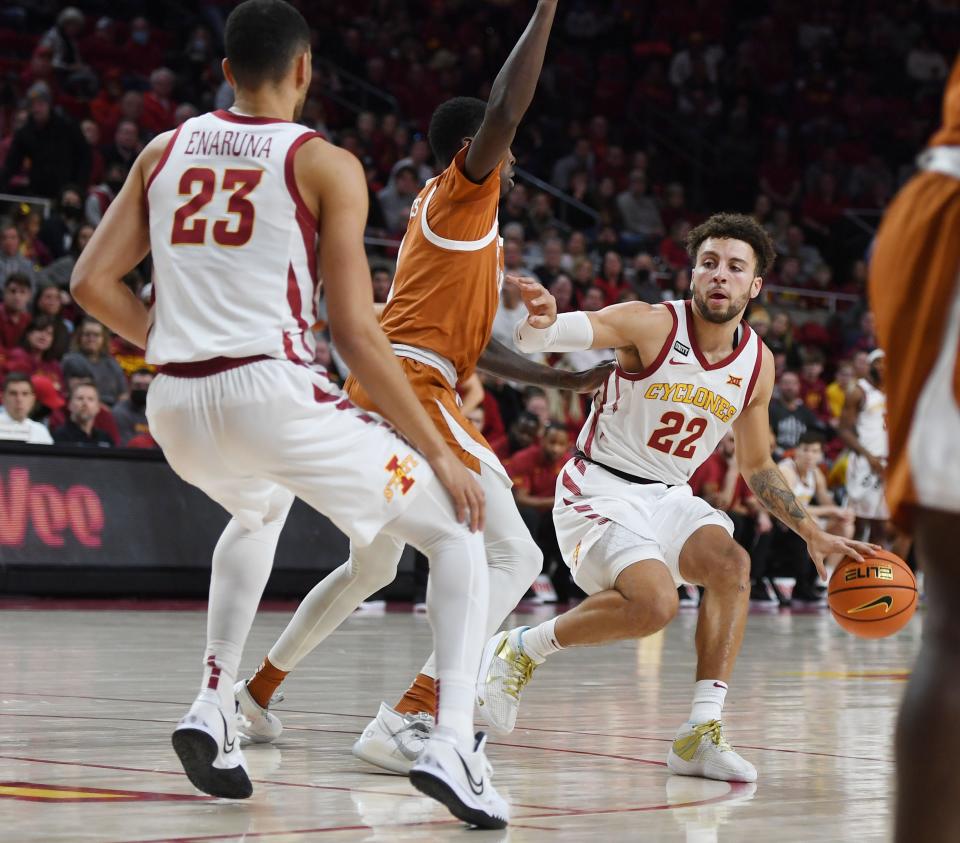 Iowa State Cyclones' guard Gabe Kalscheur (22) looks for a pass the ball around Texas Longhorns' guard Marcus Carr (2)during the first half at Hilton Coliseum Saturday, Jan. 15, 2022, in Ames, Iowa
