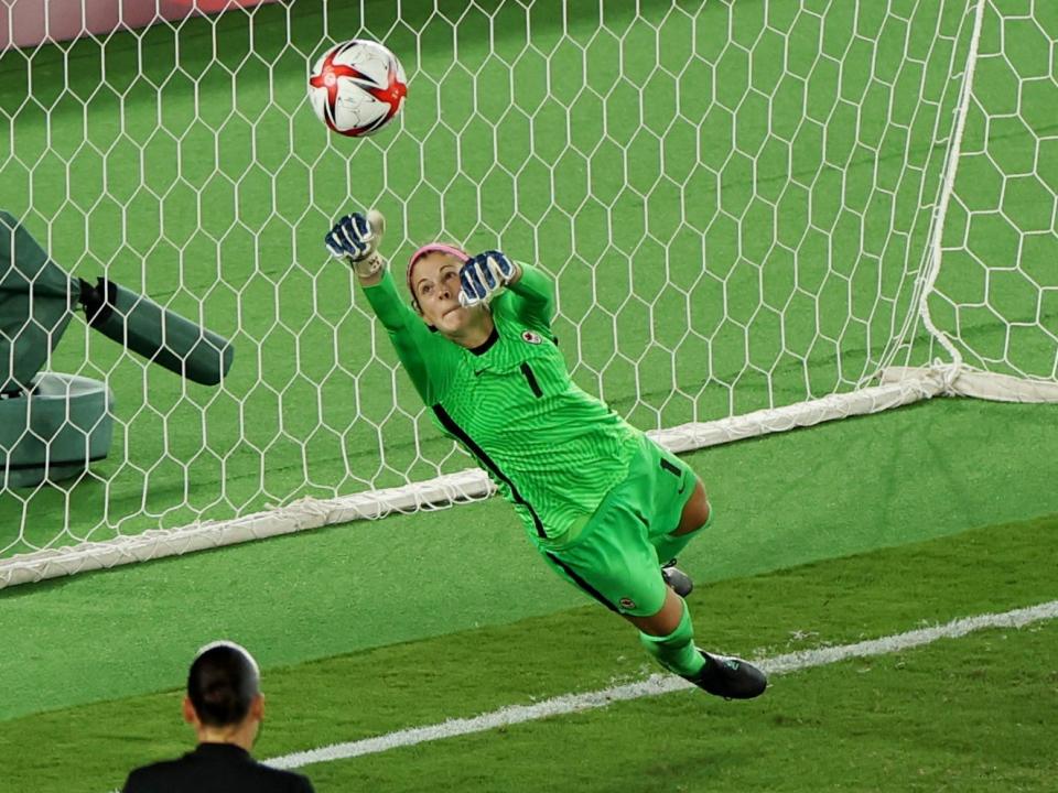 Canada's Stephanie Labbé saves a penalty from Anna Anvegard of Sweden.