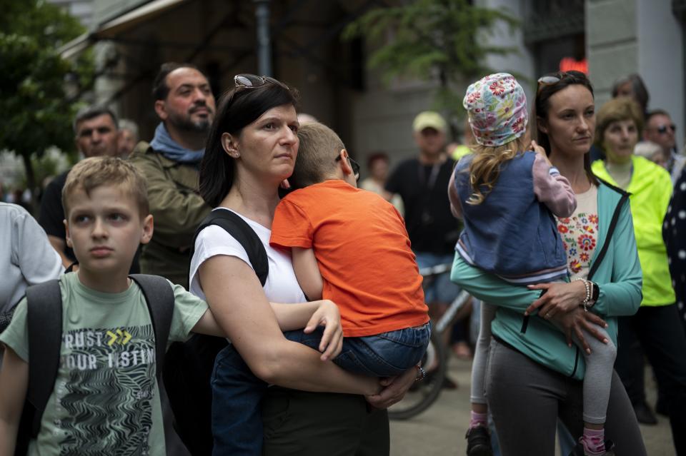 Residents gather in Debrecen, Hungary, during a demonstration against a factory that will produce batteries for electric vehicles on Tuesday, May 23, 2023. Residents, environmentalists and opposition politicians are worried that a sprawling battery factory will exacerbate existing environmental problems and use up the country's precious water supplies. (AP Photo/Denes Erdos)