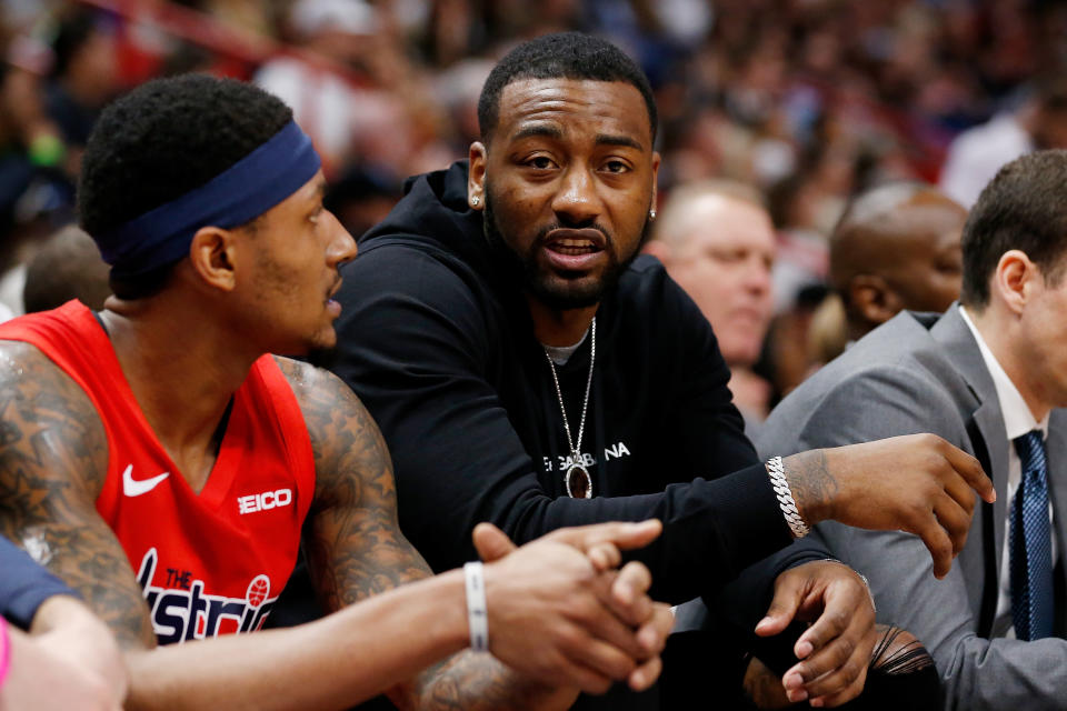 John Wall of the Washington Wizards looks on from the bench.