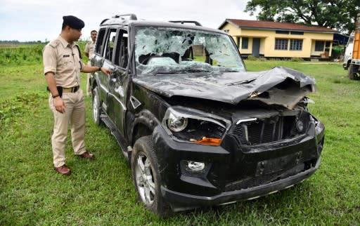 Gulshan Daolagupu, deputy superintendent of police, discusses the vehicle in which two men were lynched in Karbi Anglong district, some 180km from Guwahati, the capital of Indias northeastern state of Assam, at Dokmoka Police station on July 10, 2018