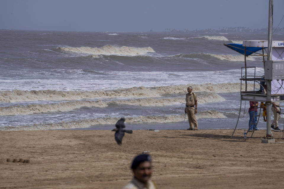 Police officers patrol during high tide at a deserted Juhu beach on the Arabian Sea cost in Mumbai, India, Tuesday, June 13, 2023. India and Pakistan braced for the first severe cyclone this year expected to hit their coastal regions later this week, as authorities on Monday halted fishing activities, deployed rescue personnel and announced evacuation plans for those at risk. From the Arabian Sea, Cyclone Biparjoy is aiming at Pakistan's southern Sindh province and the coastline of the western Indian state of Gujarat. (AP Photo/Rafiq Maqbool)